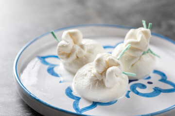 Italian burrata cheese made from mozzarella with cream inside from Apulia region