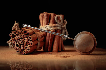 Ground cinnamon, cinnamon sticks, tied with jute rope.