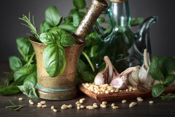 Ingredients for pesto on a wooden table.