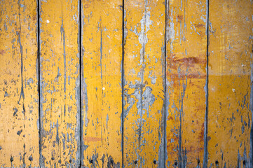 Old boards with cracked yellow paint. Classic rustic background.