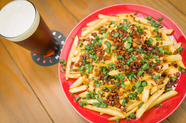 Tasty french fries, cheddar and bacon close-up