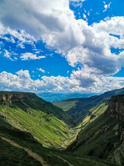 A girl against the background of the Khunzakh valley, Khunzakh waterfalls, a canyon in Dagestan 2021