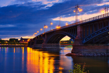 Fototapeta na wymiar Theodor-Heuss bridge in Mainz, Rhineland-Palatinate, the connection between Mainz and Wiesbaden in the blue hour with water reflection