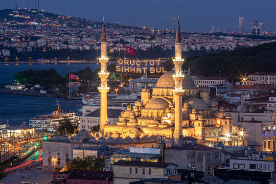 Mahya is among the minarets of Eminonu New Mosque during Ramadan. Among the minarets of the New Mosque, "Fasting and find health" is written on the ridge. Istanbul Landscape in Ramadan.