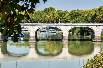 Fototapeta na wymiar One of the many bridges in Rome over the river Tiber