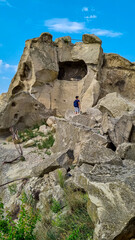 A male tourist exploring the ancient cave city of Uplistsikhe overlooking the Mtkvari river in the Shida Kartli Region of Georgia, Caucasus, Eastern Europe. Sightseeing, tourism, walking. Near Gori