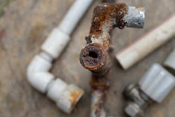 Rusted and oxidized galvanized water pipe, closeup of waste in old water pipes Clogged debris and...