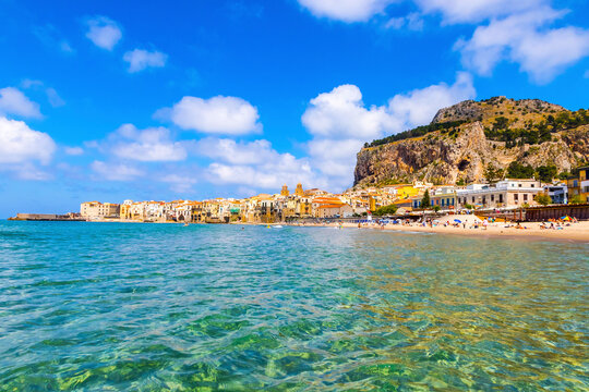 Picturesque view of Cefalu beach, Cefalu town, Sicily, Italy. Cefalu has a long and lovely beach with clean, golden sand. Mount La Rocca di Cefalu on background
