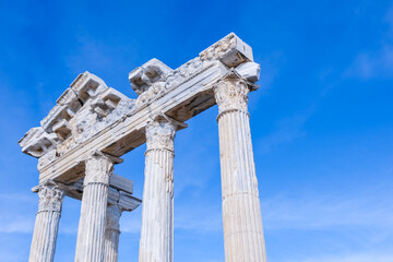 Temple of Apollo with blue sky background, Greek and Roman ancient historical antique marble columns in Side Antalya Turkey, close-up shot, copy space.
