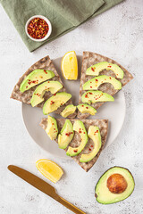 Crisp rye bread sandwiches with avocado slices