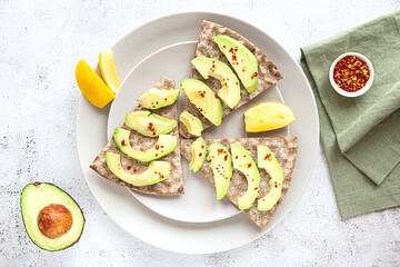 Crisp rye bread sandwiches with avocado slices