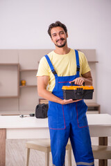 Young male carpenter working at home