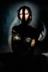 Studio portrait of a girl with an original light