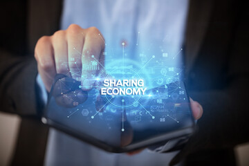 Businessman holding a foldable smartphone, new business concept