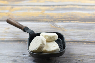 Semi-finished frozen cottage cheese syrniki. Raw meals, blanks from shop. Fast food, saves time in...