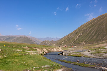 The Terek (Tergi) river flows down the Truso Valley near the Ketrisi Village Kazbegi District,Mtskheta in the Greater Caucasus Mountains,Georgia.Ketrisi village and Zakagori Fortress in the distance