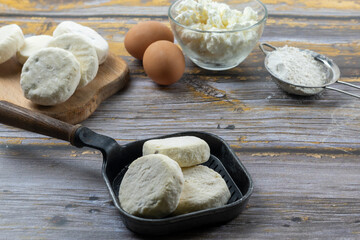 Semi-finished frozen cottage cheese syrniki. Raw meals, blanks from shop. Fast food, saves time in the kitchen. Hand made food.