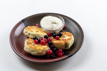 Syrniki or syrniki with cottage cheese and currant berries. Healthy breakfast concept. Delicious dessert or sweet breakfast.