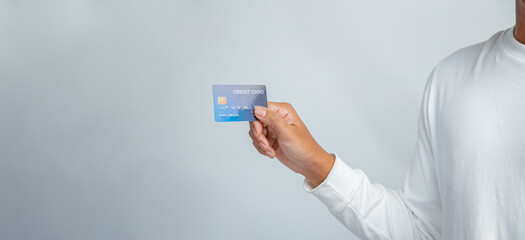 Hand holding business credit isolated on white background