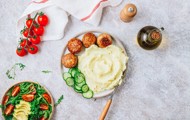 Turkey patties served with mashed potato and fresh salad