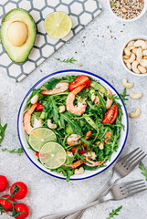 Shrimps salad with tomato, arugula, avocado and cashew nuts