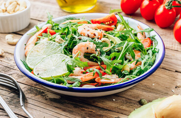 Shrimps salad with tomato, arugula, avocado and cashew nuts