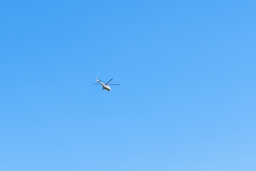 Fototapeta na wymiar Helicopter against blue sky, copy space. Military theme