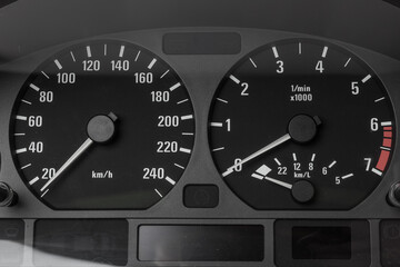 The dashboard of the car with white arrows with a speedometer, tachometer and other tools to...