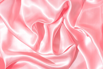 
 Texture of pink, calmy coral silk fabric, shiny folds of draperyn n the white marble background . Beautiful emerald, soft satin fabric drapery. Trends of colors, texture, background, pattern