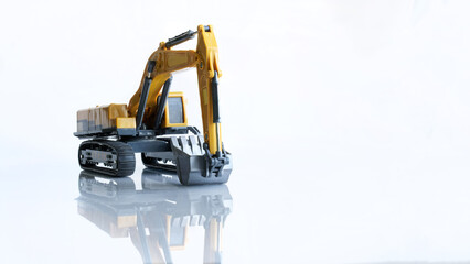 Yellow toy excavator on a light background with reflection. Construction and road equipment. Concept of construction and earthworks using an excavator. Copy space for an inscription