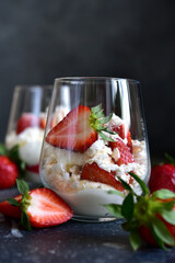 Traditional english dessert eton mess with meringue, whipped cream and fresh berries.