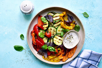 Grilled vegetables with yoghurt sauce. Top view with copy space. Top view with copy space.