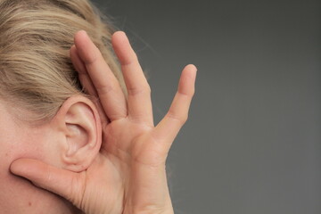 suffering from deafness and hearing loss on grey background stock photo