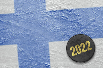 Image of Finnish flag on ice and hockey puck