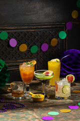 Alcoholic cocktails, Mardi Gras decoration on dark background