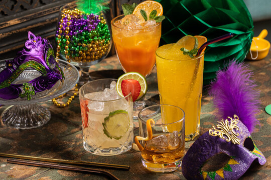 Alcoholic cocktails, Mardi Gras decoration on dark background
