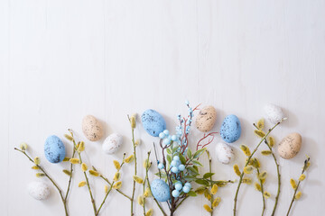 Willow branches and decorations, easter eggs on a light background. Happy easter flat lay concept