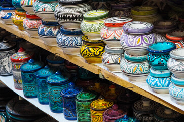 Handmade colourful decorated bowls or cups on display at traditional souk - street market in Morocco