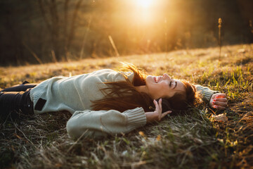 Woman Lying Down On The Meadow And Enjoying Sunset