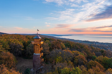 Aerial view about the freshly renovated lookout tower at Révfülöp. Lake Balaton and cloudy autumn sunrise at the background. Hungarian name is Fülöp-hegyi Millenniumi kilátó.