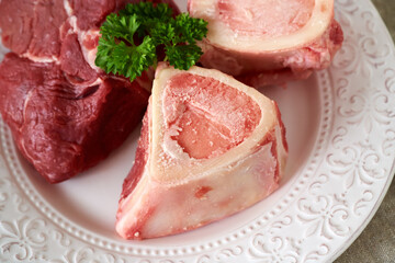 Ingredients for beef bone broth or soup - fresh marrow bones and beef meat