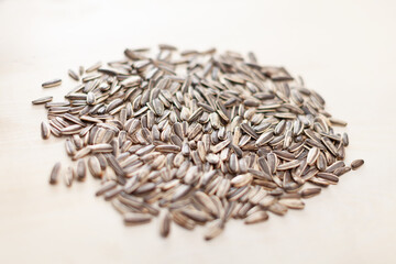 dry roasted sunflower seeds on white wooden surface