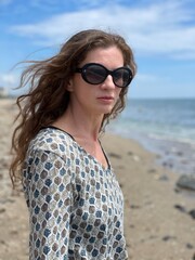 Woman on the beach with black sunglasses