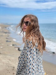 Woman on the beach with black sunglasses