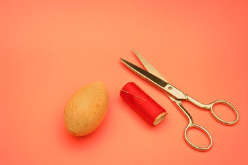 Fototapeta na wymiar Scissors, thread and sewing egg. repairs clothing arrangements.