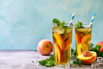 Cold summer delicious peach tea in a tall glasses.