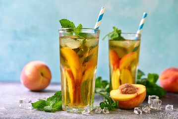 Cold summer delicious peach tea in a tall glasses.