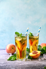 Cold summer delicious peach tea in a tall glasses.