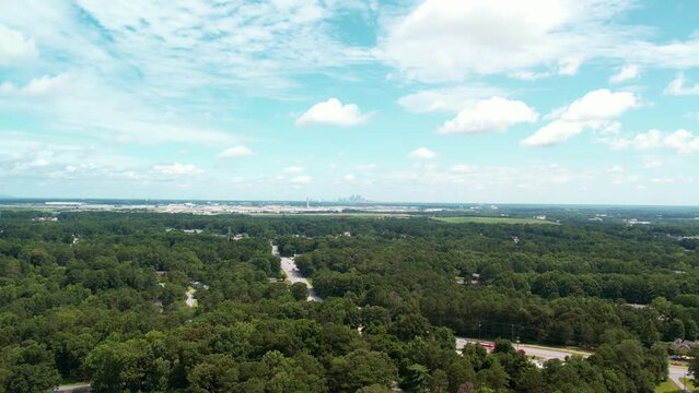 Aerial drone Pull away from major airport showing city in the background.