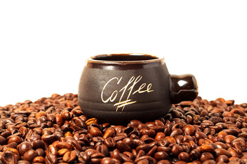 Clay cup with coffee inscription on coffee beans.